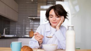 a woman sitting at a table with a plate of food